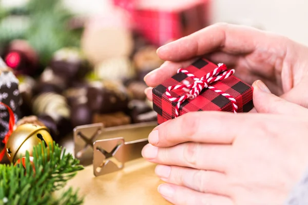 Wrapping assorted chocolates in small boxes