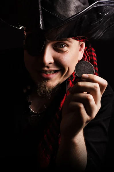 Joyful pirate with ancient coins in hand