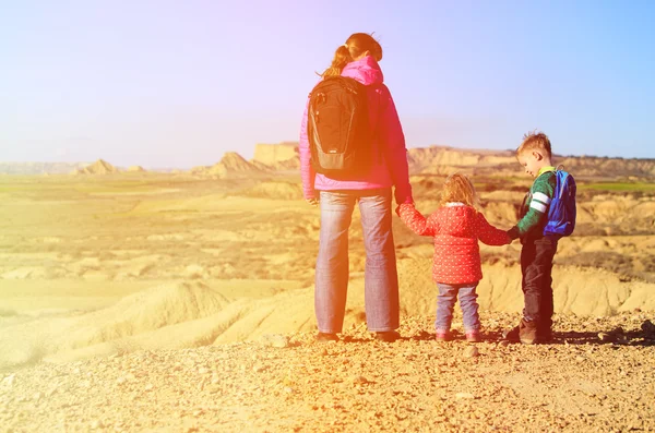 Mother with kids travel in scenic mountains
