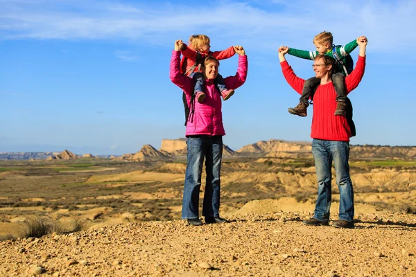 Family with two kids travel in scenic mountains
