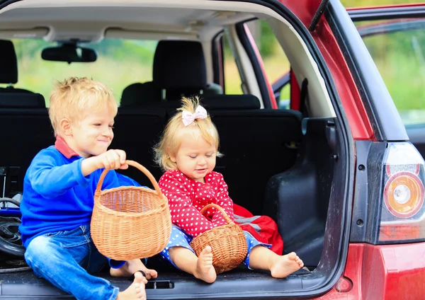 Little boy and toddler girl travel by car