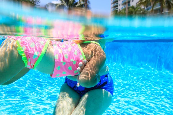 Grandmother teaching granddaughter to swim