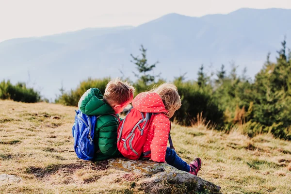 Little boy and girl travel in mountains