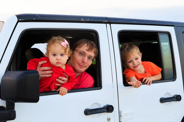 Family driving off-road car on tropical beach
