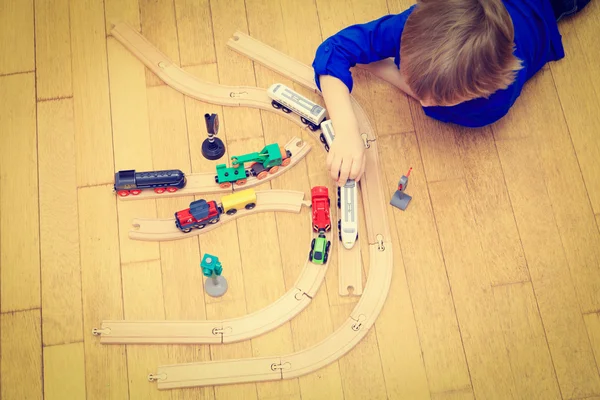 Child playing with trains indoor