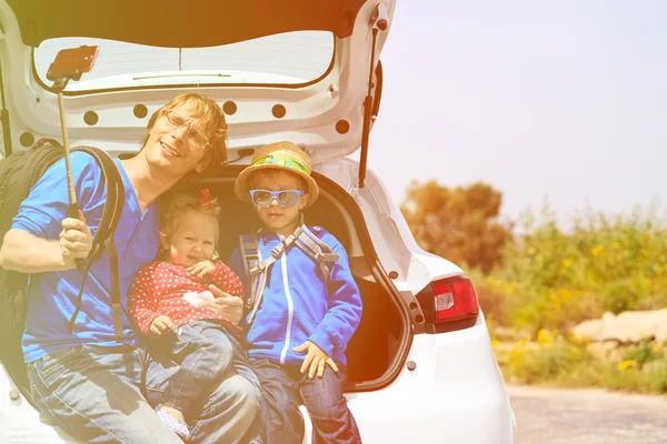 Family taking selfie while travel by car