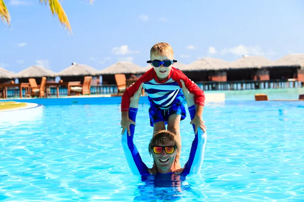 Father and son having fun in swimming pool