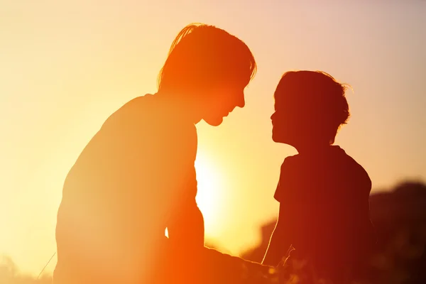 Father and little son at sunset, family concept