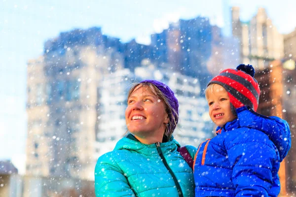 Mother and son enjoy first snow in the city