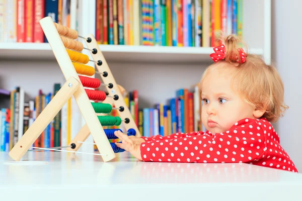 Little girl playing with abacus, early learning