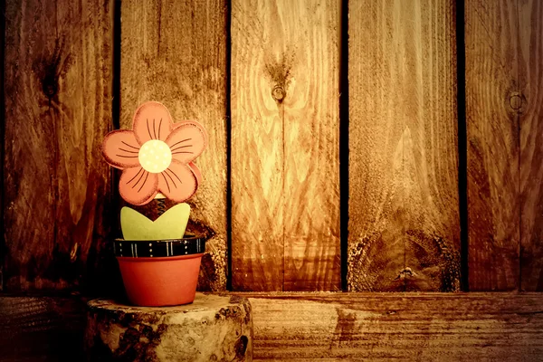 Flower and wooden wall