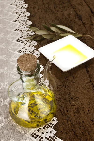 Glass jar with olive oil rustic background