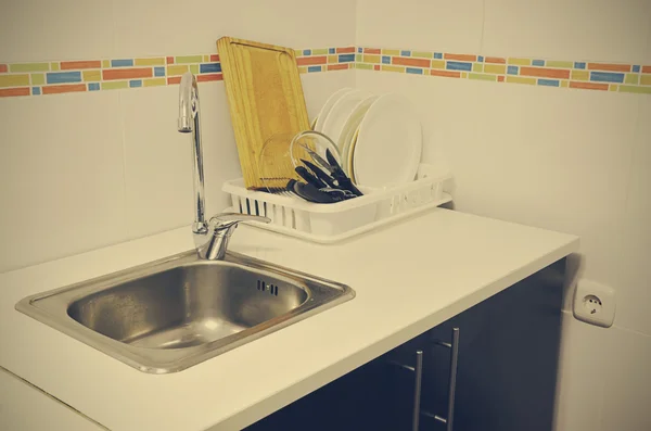Sink and scrubbed dishes in the kitchen