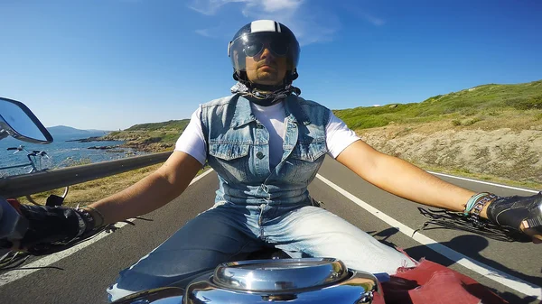 Riding a classic motorcycle on a clear day