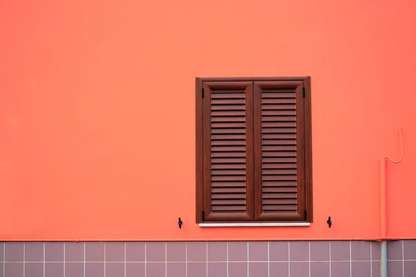 Window in an orange and gray wall