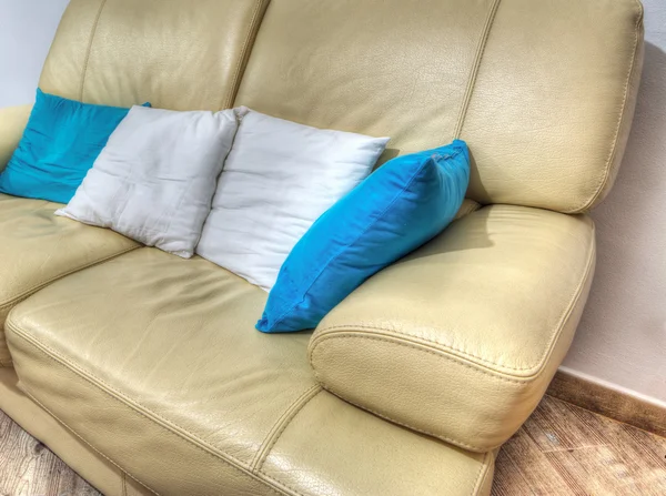 Leather couch with pillows in a living room in hdr
