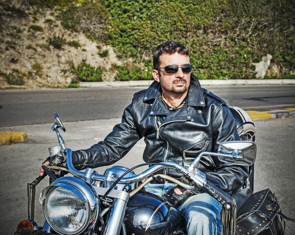 Biker on a classic motorcycle in hdr