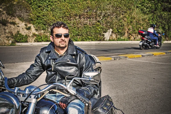 Biker and motorcycle in sepia tone