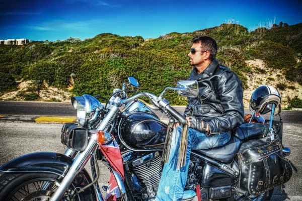 Side view of a biker on a classic motorcycle