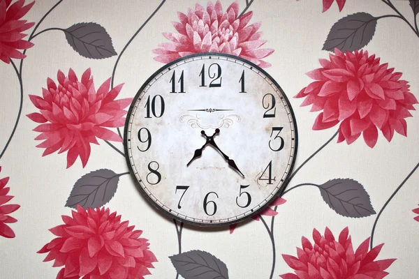 Wall clock isolated on the on colored wallpaper