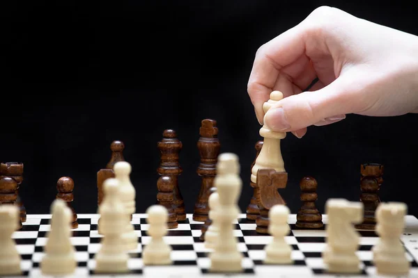 The beginning of a chess game and a hand