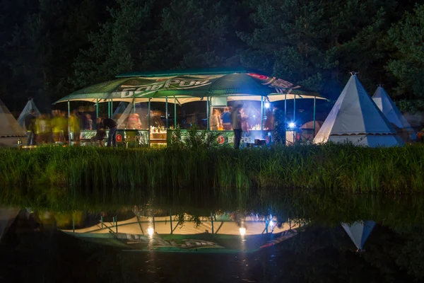 Night party under the tent on the lake