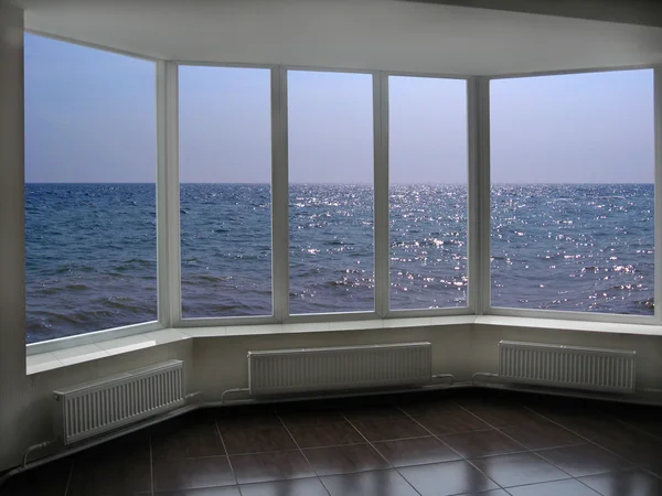 Big office windows with view of marine waves