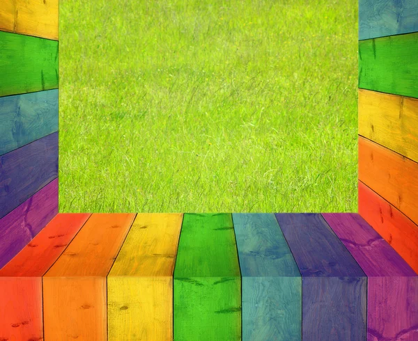 Table from multicolored wooden boards and grass