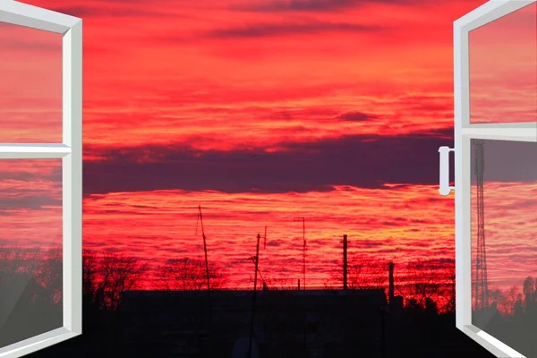 Window opened to the dark scarlet sunset