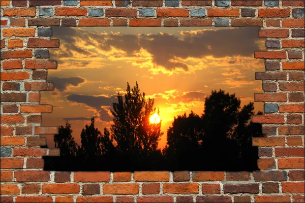Broken brick wall and view to the sunset