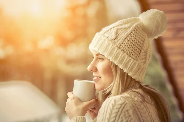 Female with cup of coffee at winter