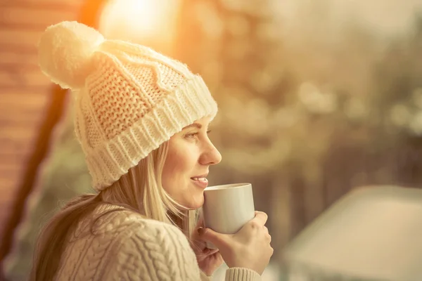 Female with cup of coffee at winter