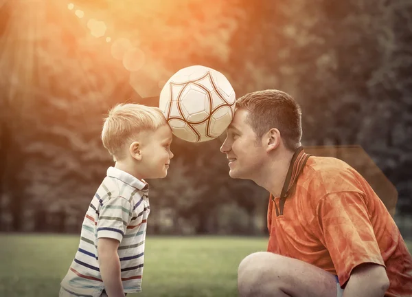 Father and son playing football