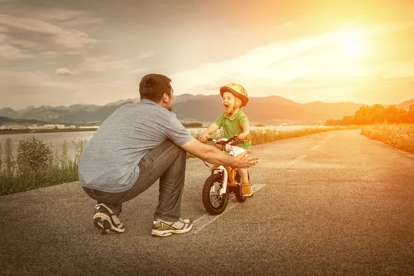 Father and son on bicycle