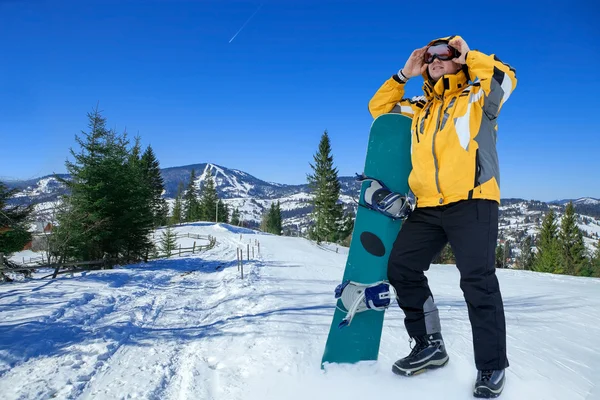 Men in goggles with snowboard