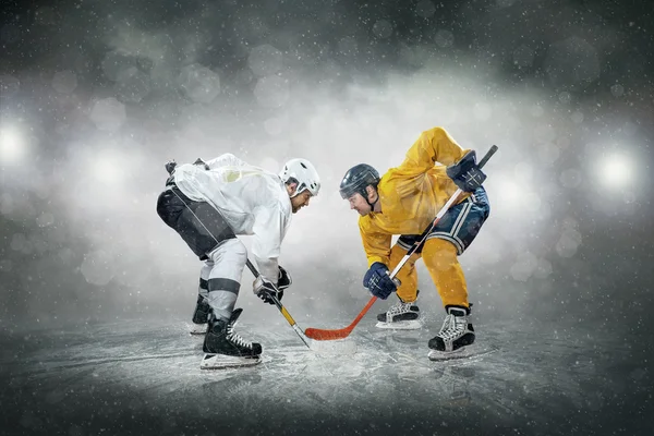 Ice hockey players on ice.