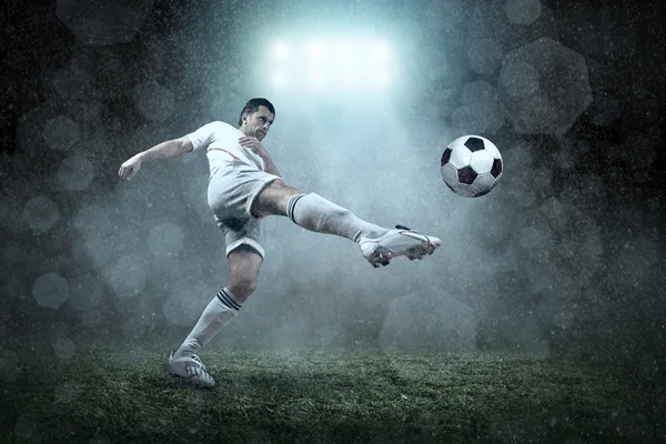 Soccer player with ball in action