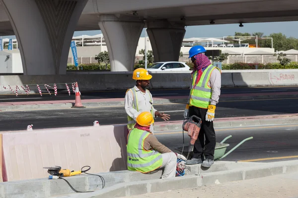 DUBAI, UAE - DEC 16: Construction workers in the city of Dubai. December 16, 2014 in Dubai, United Arab Emirates