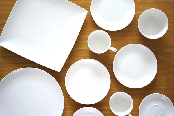 Collection of porcelain plates on wooden table