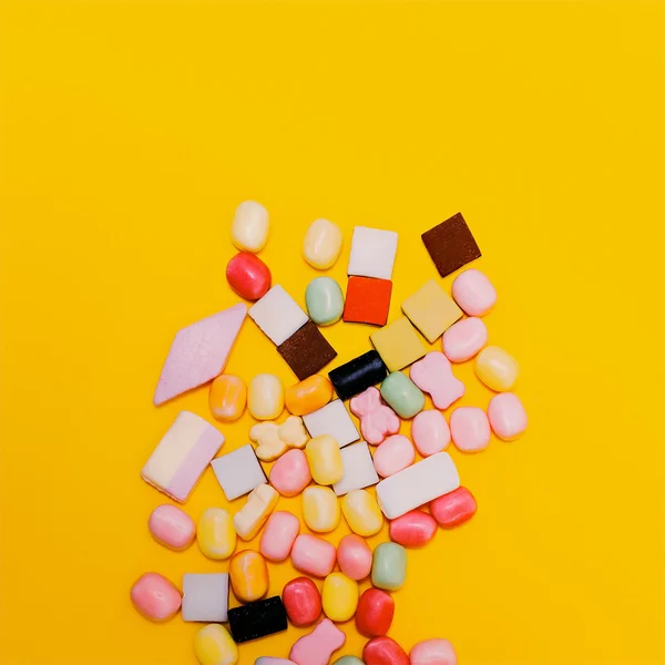 Assorted Sweets on yellow background. Minimalism
