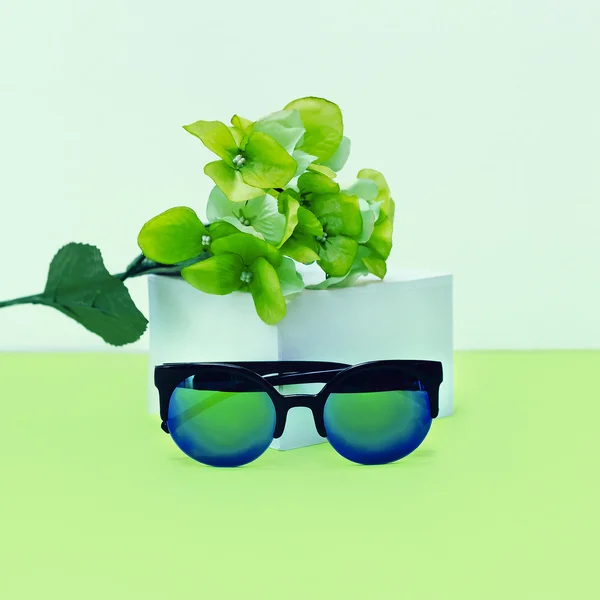 Fresh Mix. Fashionable sunglasses and flowers. Green accent.