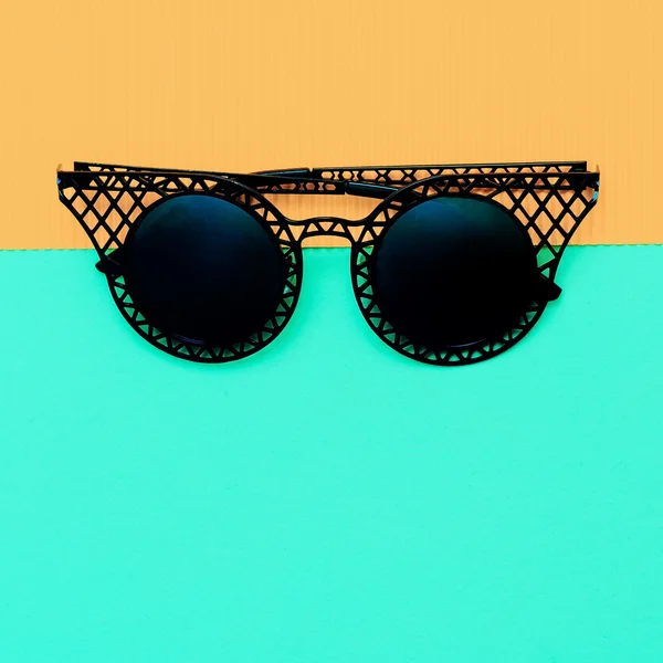 Black stylish sunglasses on bright background. Minimalism fashio