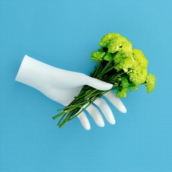 Mannequin Hand holds green flowers Minimalism art fashion