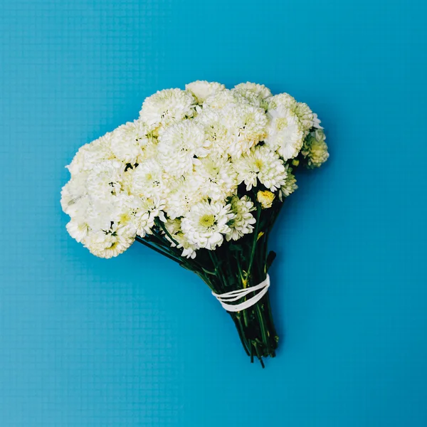 White Bouquet on blue background. Fashion. Minimalism. details