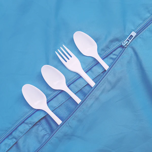 Plastic dishes on blue. Minimalism art