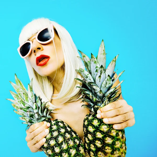 Tropical Party. Fashion blonde with pineapple on a blue backgrou