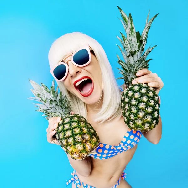 Crazy Party time. Sexy Blonde with pineapple on a blue backgroun