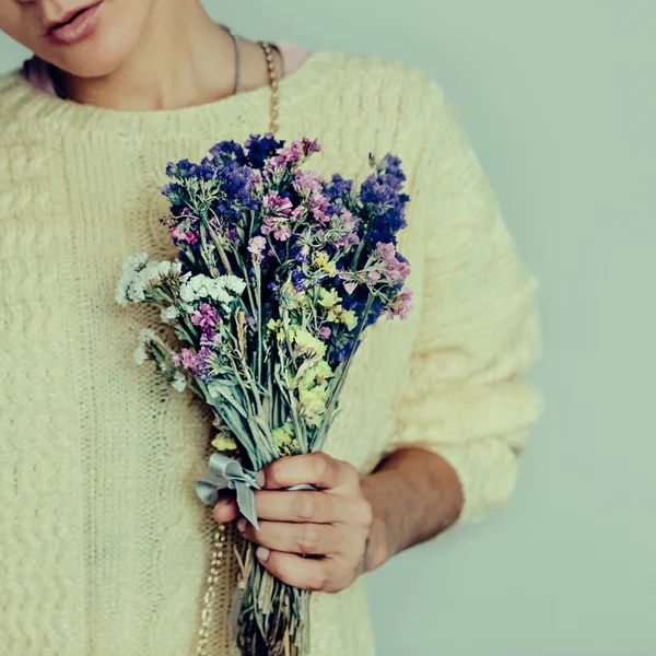 Sensual girl with bouquet of flowers. Autumn tenderness.
