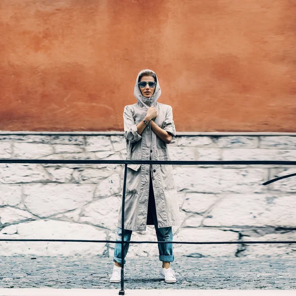 Girl standing on city street in bright wall. Active urban style.