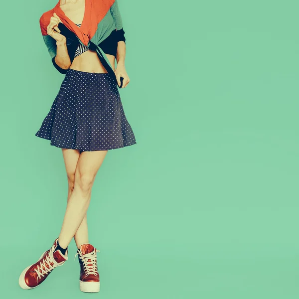Playful girl in skirt polka dot on blue background. vintage styl